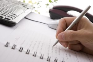 Businessman brainstorming and writing notes