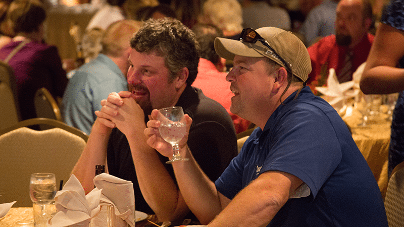 Point of Rental 2016 International Conference Attendees watch a speech while eating dinner atop Dallas.