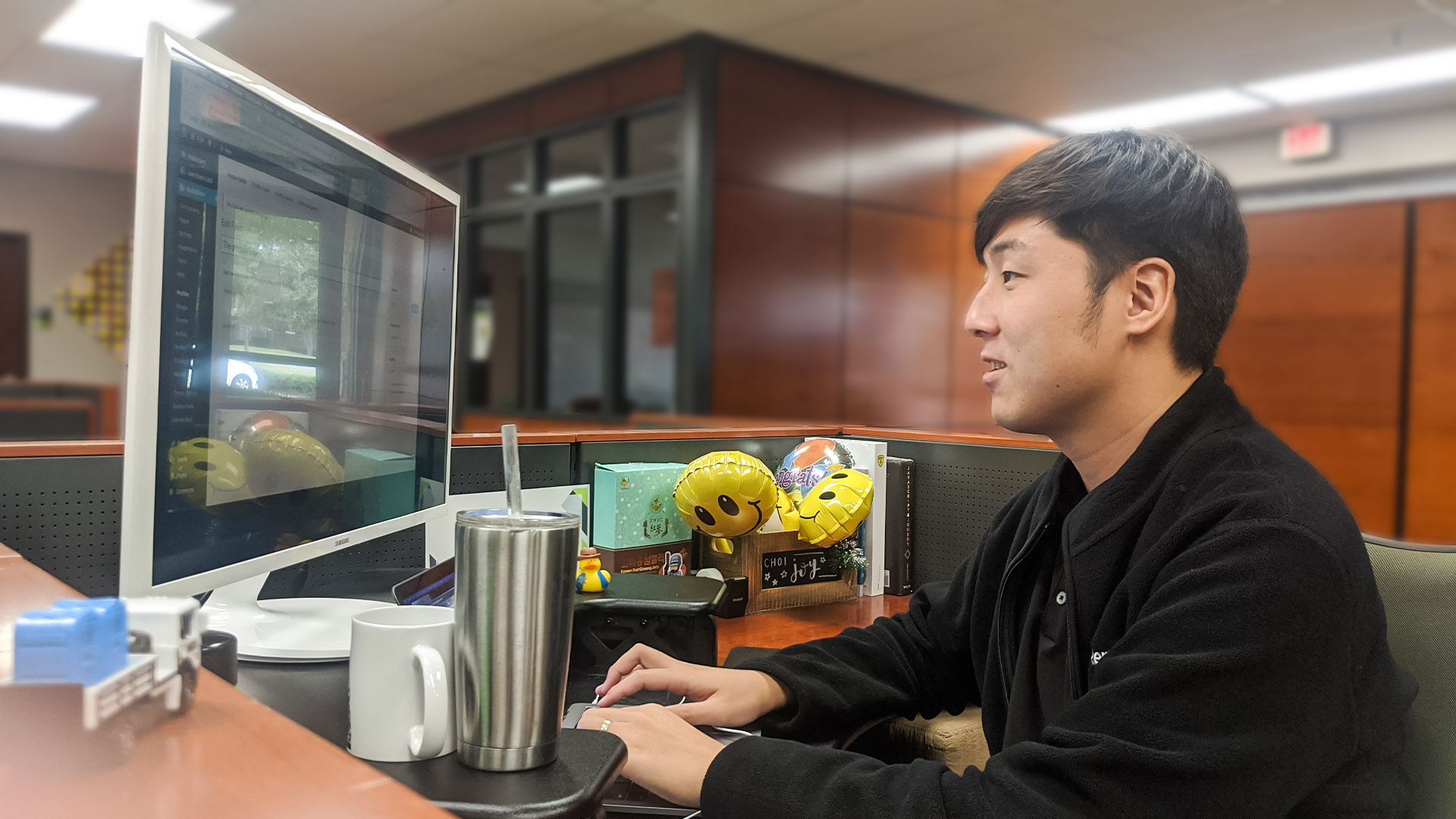 Thomas Choi works at his desk in the office.