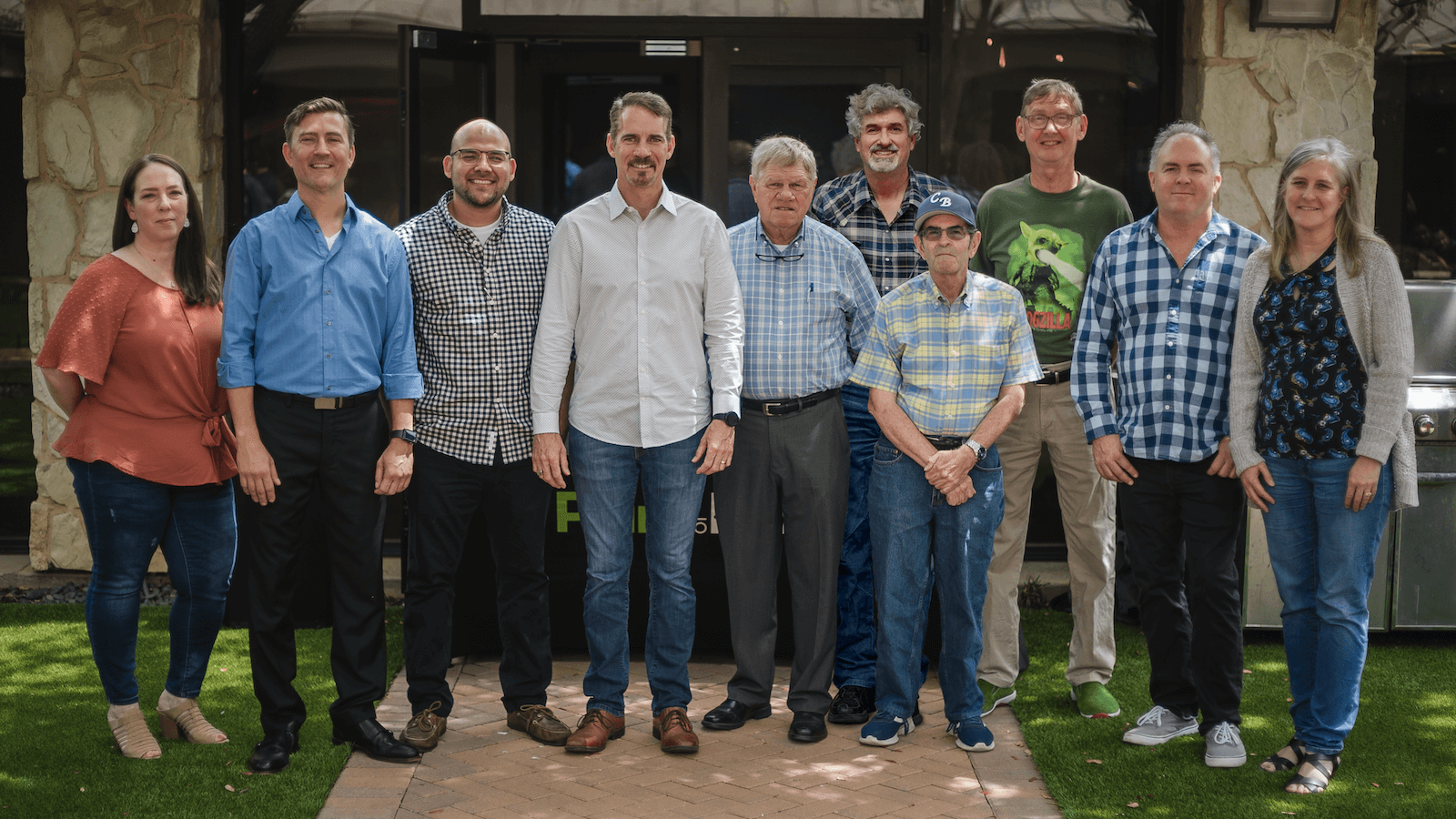 Point of Rental's 15+ year veterans pose for a picture in the Point of Rental courtyard.