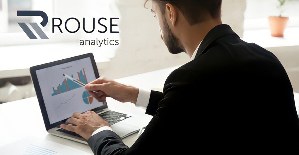Rouse Analytics cover image, man at a computer with a BI dashboard
