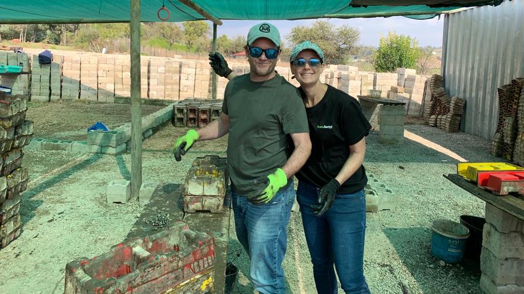 South Africa Regional Director Bernice Smith and her husband pose for a photo while making hundreds of bricks for Door of Hope, a South African charity.
