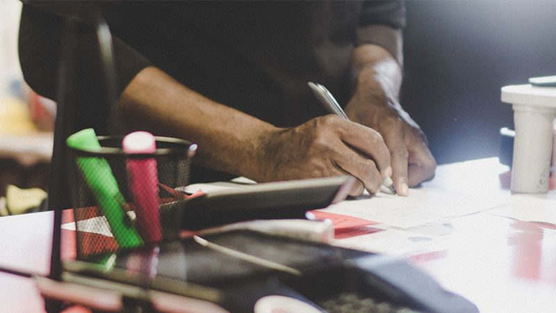 A customer signs a contract at the rental counter.