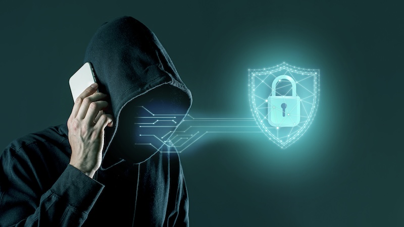 Man in a hoodie, talking on a phone