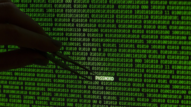 A person picking a password out of binary using tweezers