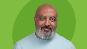 Emad Georgy headshot - a man with a clean-shaven head and a salt-and-pepper beard on a green backdrop.